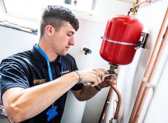 Student tightening a pipe