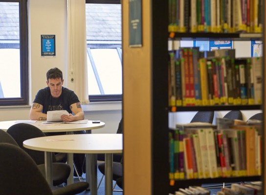 Student reading in the library