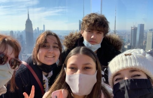 Group of students overlook a city skyline